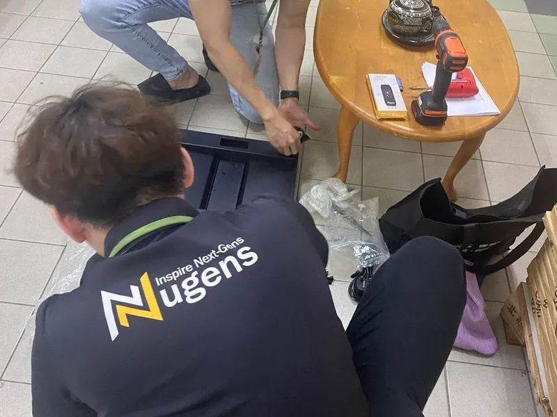 Nugens technician on-site installing digital standee for PDRM Royal Malaysia Police